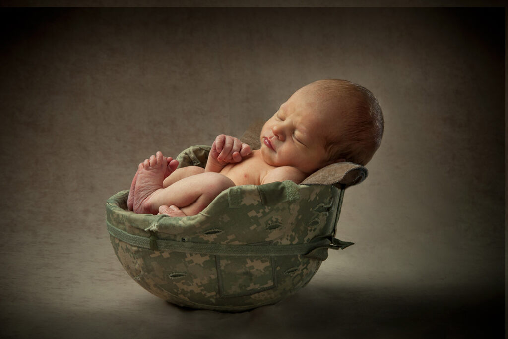 Baby in military helmet