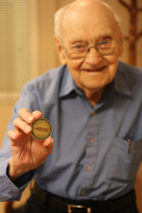 George Strauch shows off the military challenge coin gifted to him by the VSC.