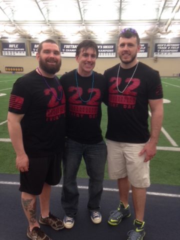 Scott Palasik (center) is flanked by two student veterans during the 2018 Out of the Darkness campus walk event at The University of Akron.