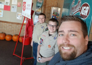 Salvation Army bell ringing for Boy Scouts with his sons Dylan (left) and Ethan (middle)