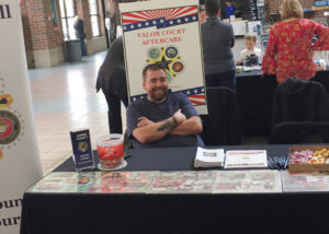 Jamie Jones manning the Valor Court table at an event in Hudson