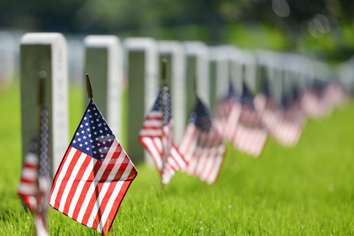 American flags in a cemetery.