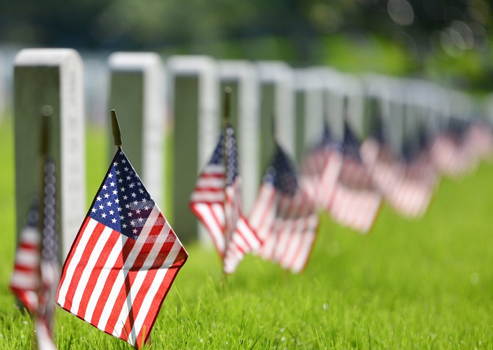 American flags in a cemetery.