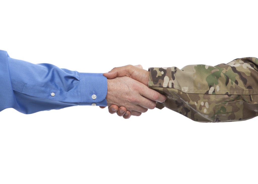 Soldier and businessman shaking hands