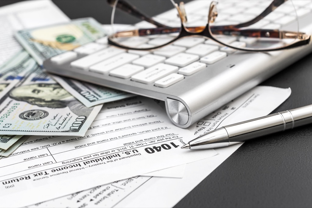 Money, a keyboard, and tax forms