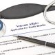 Clipboard with application for VA Health Benefits.