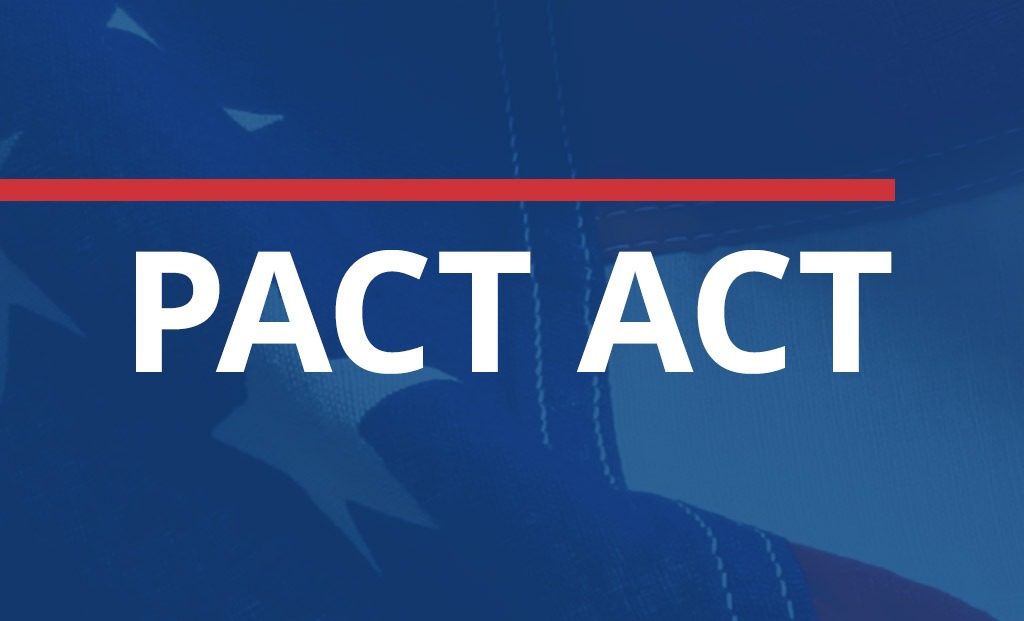 PACT ACT text overtop American flag