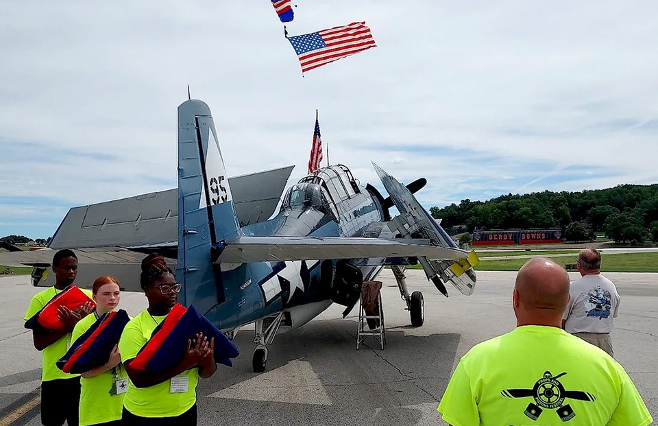 American flag overtop a plane at the 2022 Props and Pistons Festival