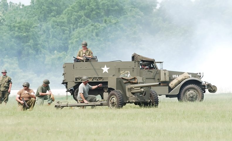 Men in a field reenacting a battle.