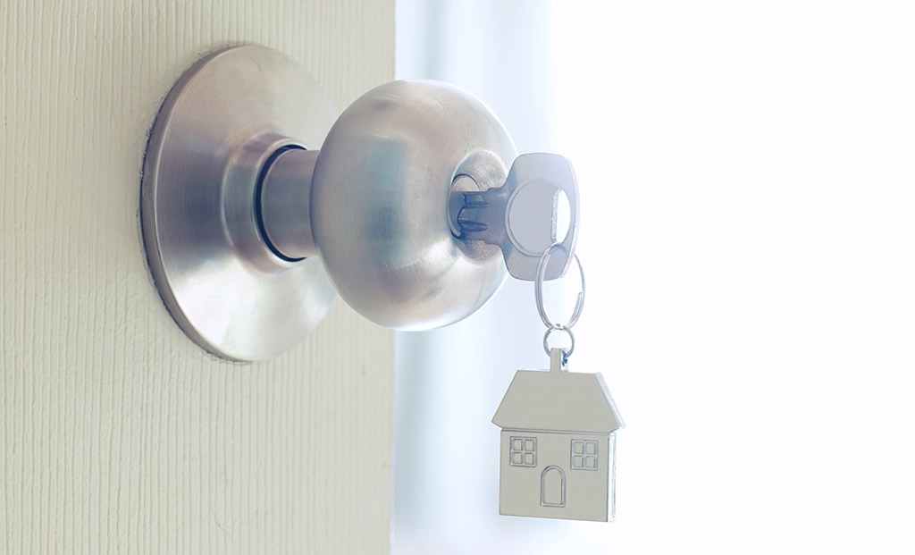 Door knob with a key and a house keychain